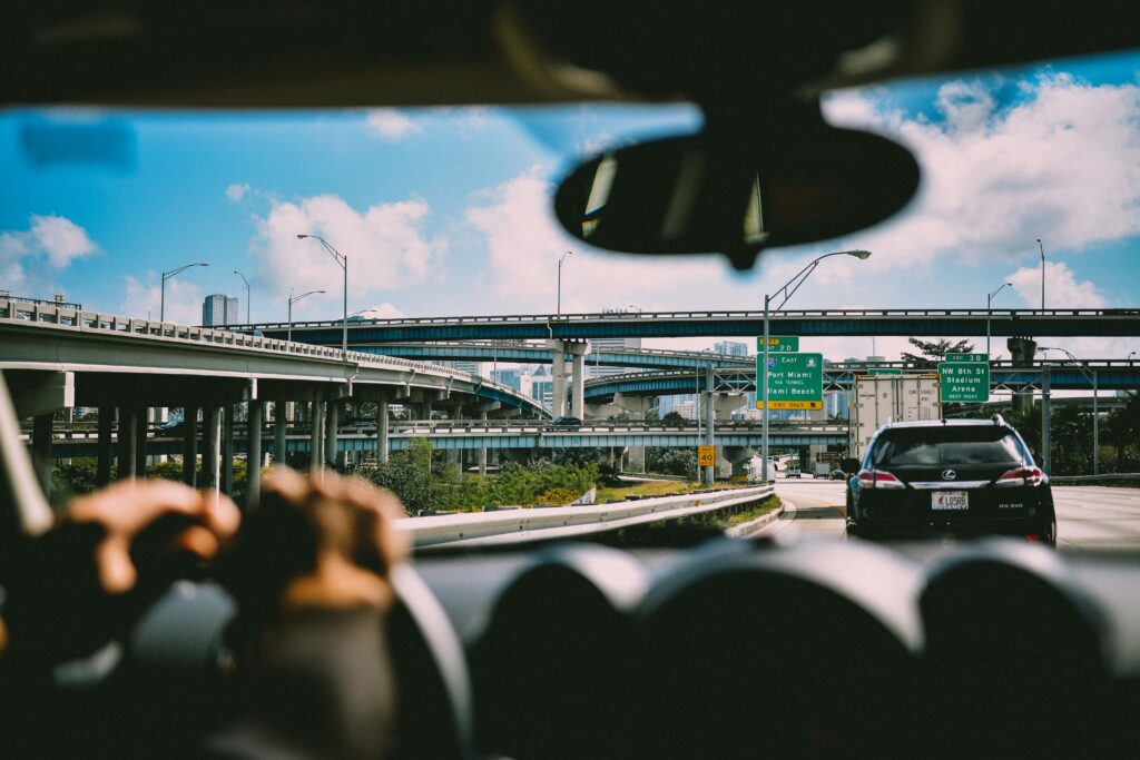 the dashboard of a car driving on the miami florida freeway